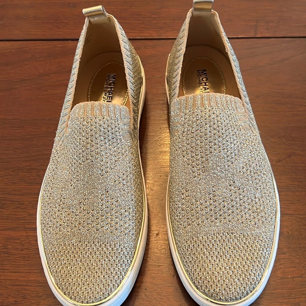Michael Kors gold sneakers. never been worn. size 7 but fit like 7 1/2